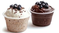 Two gourmet cupcakes with creamy frosting and fresh blueberry toppings on white background, perfect for bakery menus and dessert marketing materials.