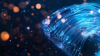 Glowing blue fiber optic strands curve against dark background with orange bokeh lights, creating modern technology and communication concept.