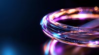 Glowing circular light trail with vibrant blue and pink neon colors against dark background creates dynamic motion effect for technology and abstract designs.