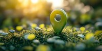 Green location pin marker on grass with sunlight bokeh background, representing eco-friendly navigation, sustainable tourism and outdoor adventure concepts.