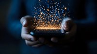 Magical glowing golden sparkles floating above cupped hands in dark blue atmosphere, creating mystical light effect and ethereal ambiance for fantasy concepts.
