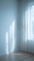 Bright sunlight streams through sheer white curtains into a minimalist room with pale blue walls and wooden flooring, creating soft shadows and an airy, serene atmosphere ideal for interior design and lifestyle projects.