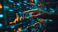 Hand pointing at financial chart on digital screen with glowing blue and orange market data visualization showing stock price movements and trading analysis.