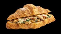 Croissant sandwich with melted cheese and greens isolated on transparent background, ready for menu design, food packaging, restaurant graphics, print-on-demand products and digital culinary content.