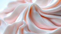 Flowing white silk fabric with soft pink and orange highlights creating elegant waves and curves for luxury textile and fashion design backgrounds.