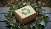 Eco-friendly cardboard shipping box with green recycling symbol surrounded by natural eucalyptus branches on dark wooden surface for sustainable packaging.
