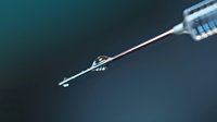 Close-up of medical syringe needle with liquid droplet against dark teal background, showcasing precision in healthcare and vaccination procedures.