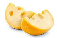 Fresh yellow cheese pieces with round holes on white background, dairy product closeup macro photography isolated for food packaging and menu design.