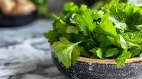 Fresh green parsley leaves in rustic ceramic bowl on marble surface, close up view with soft natural lighting and shallow depth of field for culinary use.