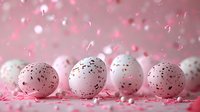 Speckled pink and white Easter eggs with colorful confetti scattered on pink background with bokeh effect and falling glitter creates festive spring atmosphere.