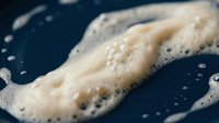 Sourdough starter with active bubbles and fermentation process for artisan bread baking and homemade cooking projects.
