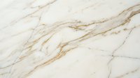 Elegant white marble surface with golden brown veining patterns creating luxurious natural stone texture for interior design and architectural applications.