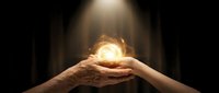 Hands holding glowing orb of light against dark background, symbolizing hope, energy, innovation, and spiritual power for business and wellness concepts.