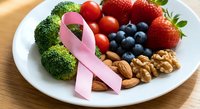 Pink ribbon with healthy foods broccoli strawberries blueberries nuts tomatoes on white plate for breast cancer awareness nutrition support.