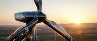 Modern wind turbine close-up view during golden hour sunset showcasing renewable energy technology and sustainable power generation in rural landscape.