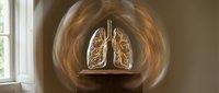 Glowing neon lungs anatomy model displayed in circular light tunnel, medical education and respiratory health awareness concept.