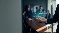 Business professional using holographic technology interface with glowing data visualization in modern corporate office environment for digital transformation.