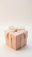 Elegant pink gift box with cream satin ribbon bow on soft neutral background for special occasions and celebrations.