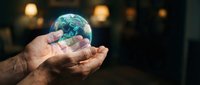 Hands holding glowing Earth globe with environmental protection concept for sustainability awareness campaigns and eco-friendly business presentations.