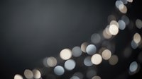 Abstract bokeh lights on dark background creating dreamy atmosphere for holiday celebrations and festive decorations.