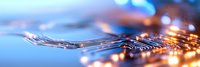 Macro view of electronic circuit board with glowing connections and bokeh lights in blue and orange tones creating futuristic technology background.