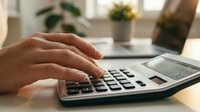 Professional accountant calculating finances on calculator at modern office desk with laptop and plants in background for business planning.