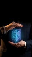 Businessman in formal suit holding glowing neon shield with security lock symbol, representing data protection, cybersecurity, and digital safety for business and technology concepts.