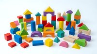 Colorful wooden building blocks set with geometric shapes including cubes, cylinders, triangles and arches isolated on white background for educational play.