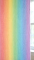 Vibrant rainbow gradient curtain panel with smooth color transitions from pink to purple, hanging in bright window for home decor and interior design.