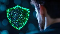 Glowing green shield symbol with particles against dark background, representing digital security and cyber protection concept for business technology.