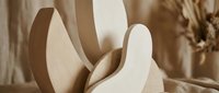 Modern abstract wooden sculpture with curved flowing forms in warm beige tones, contemporary art piece for minimalist interior design and home decor.