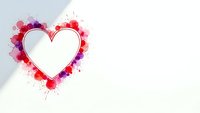 Heart frame with colorful watercolor splashes in pink red purple on white background for romantic design projects and love themed artwork.