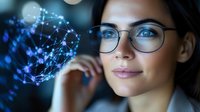 Young professional woman with glasses analyzing glowing blue digital network connections and data visualization in modern tech environment.