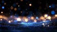 Magical glowing blue and gold bokeh lights on dark background with sparkles and glitter effect creates dreamy atmospheric mood for festive designs.