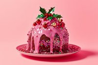 Pink glazed holiday bundt cake decorated with holly berries and leaves, sprinkled with glitter on pink plate against rosy background. Festive winter dessert.
