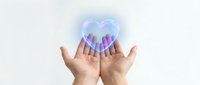 Open hands presenting glowing holographic heart with geometric patterns symbolizing love, care, healthcare technology and digital wellness concepts.