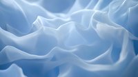 Soft light blue flowing fabric with smooth silky waves and gentle folds, creating an elegant abstract textile background for design projects.