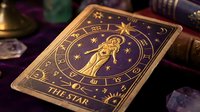 Ornate golden tarot card featuring The Star arcana with celestial figure pouring water under starry night sky, surrounded by mystical crystals and books.