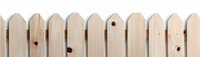 Unfinished wooden picket fence panel with natural pine texture and visible knots, ideal for garden borders and DIY home improvement projects.