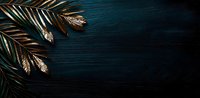 Golden palm leaves against dark teal wooden background with dramatic lighting and copy space, creating moody tropical minimalist composition.
