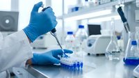 Laboratory scientist in blue gloves using pipette for precise sample analysis in modern research facility with scientific equipment and test tubes.