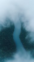 Aerial view of misty turquoise river winding through dense forest landscape with fog rolling over treetops creating mysterious atmospheric mood. Suitable for nature and travel themes.