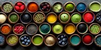 Colorful spices, herbs and superfoods in small bowls arranged in rows. Vibrant cooking ingredients for healthy cuisine and culinary arts.