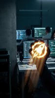 Glowing lightbulb held in hand with rocket symbol inside, symbolizing innovation and startup ideas in modern tech office workspace with multiple computer monitors.