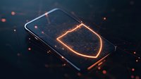 Glowing shield protection icon on smartphone screen with orange particles and dark atmosphere, representing mobile security and cybersecurity concept.