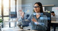 Professional Asian businesswoman interacting with futuristic holographic interface displaying data analytics and charts in modern office environment.