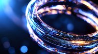 Glowing circular rings with blue and orange light effects against dark background create futuristic technological atmosphere for business and innovation concepts.
