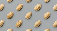 Raw almonds arranged in organized pattern on neutral gray background for healthy snacking and nutrition concepts in food photography and culinary designs.