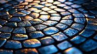 Wet cobblestone pavement with golden sunlight reflection creating dramatic pattern. Ancient European street detail showing curved stone arrangement at sunset.