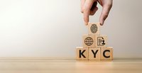 Hand placing wooden cube with fingerprint icon above KYC blocks representing know your customer identity verification and compliance procedures.